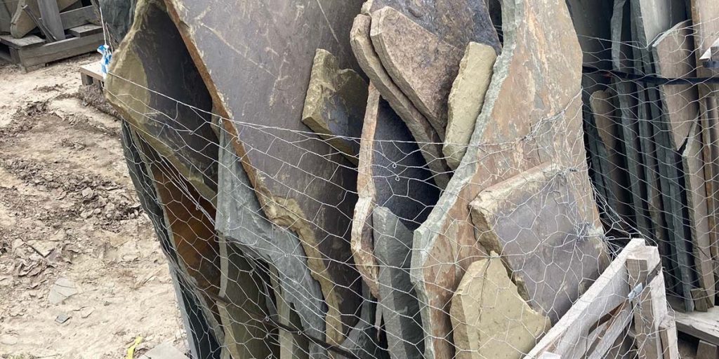 A picture of a pallet of Pennsylvania blue irregular flagstone slabs.