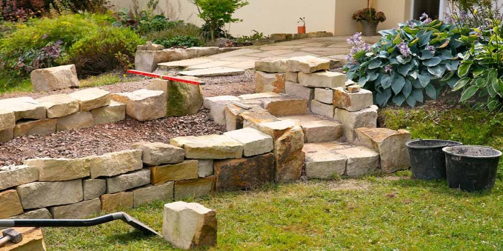 Use flagstone brick in your next landscaping project to build a tiered planter like the one in this picture.