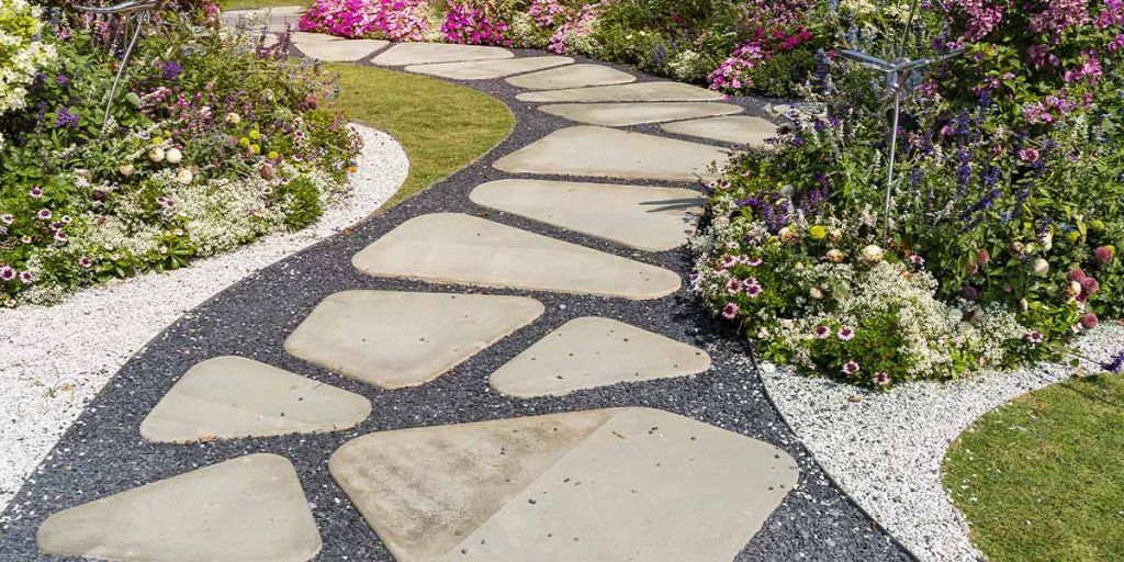 This is a picture of flagstone pavers with gravel to form a walkway through a garden.